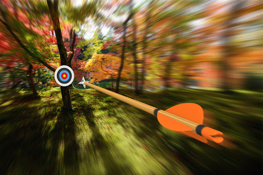 Archery concept of an arrow flying through the air at high speed toward the center of a distant target with motion blur effect. The arrow and target are rendered in 3D. this is to resembles sales prospecting strategies