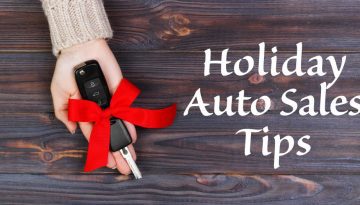 A woman extending a vehicle key with a red bow with the text "holiday auto sales tips" in white next to the key.